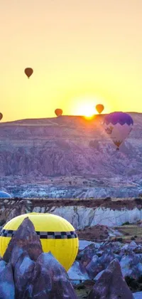 This mobile wallpaper features a group of hot air balloons flying over a valley in a stunning lavender and yellow color scheme