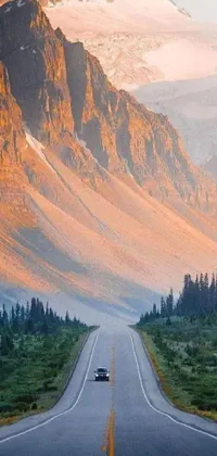 Get mesmerized by the natural beauty of this live wallpaper depicting a car journey across mountains in Canada