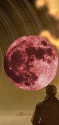 This phone live wallpaper features an album cover-inspired image with a mysterious man in front of a bright red full moon