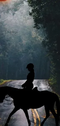 This phone live wallpaper depicts a picturesque scene of a person riding on horseback along a winding road through a forest