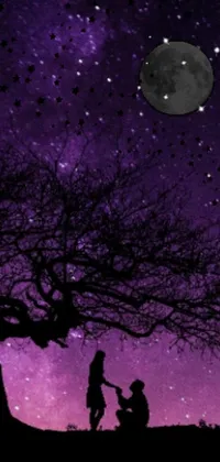 This live wallpaper for mobile devices features a captivating scene of a couple standing under a tree with a purple sky as a backdrop