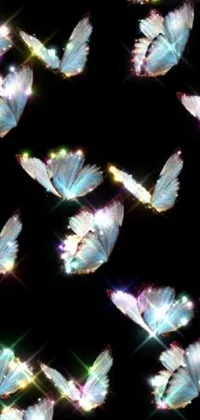 This phone live wallpaper is a beautiful display of fluttering butterflies that come alive on a black background