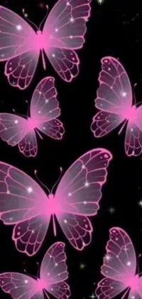 This live wallpaper depicts a group of pink butterflies flying in the air against a black background
