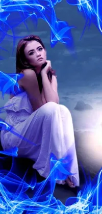 This captivating phone live wallpaper showcases a mesmerizing digital artwork of a woman dressed in white sitting on a rock