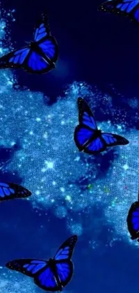 This phone wallpaper features a mesmerizing design of blue butterflies elegantly flying in the sky