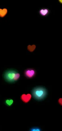 This live phone wallpaper features heart-shaped lights shining in the darkness