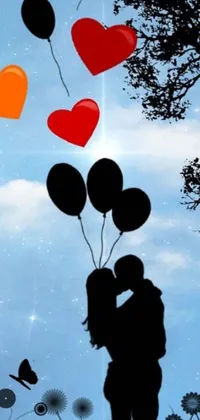 This charming phone live wallpaper depicts a romantic couple kissing under a tree with colorful balloons hovering above them