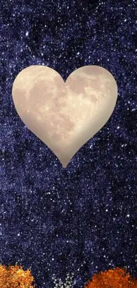 This phone live wallpaper features a heart-shaped tree formed by two trees, with a stunning yellowish full moon and space art background in shades of indigo and purples