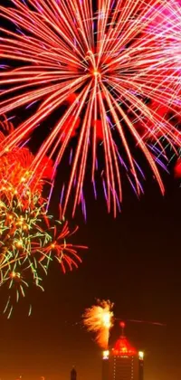 Add some sparkle to your phone with this stunning live wallpaper of fireworks lighting up the night sky in shades of yellow and red