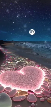 This pink heart live wallpaper features a beautiful beach scene at night