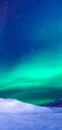 This live wallpaper features a snow-covered slope with the aurora borealis glowing in the background