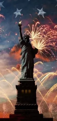 Decorate your phone screen with this stunning live wallpaper featuring the iconic Statue of Liberty standing proud and tall while a grand fireworks display bursts behind it