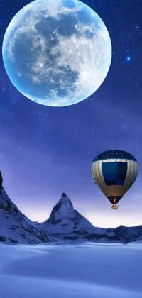 Looking for a stunning live wallpaper for your phone? Check out this captivating scene capturing a hot air balloon flying in front of a full moon as delicate snowflakes fall in the moonlight