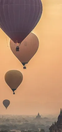 Take to the skies with this stunning phone live wallpaper! Marvel at a series of hot air balloons in a gorgeous, vivid design as they glide majestically over a bustling city