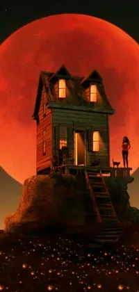 This live phone wallpaper emphasizes surrealism with a house entrenched on a hill under a red, eclipsed moon