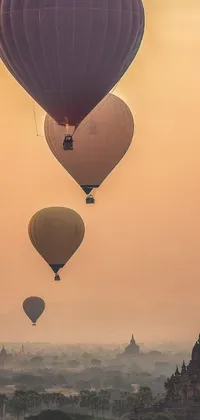 This stunning 4K vertical wallpaper features a beautiful beige mist backdrop with a group of hot air balloons flying over a cityscape