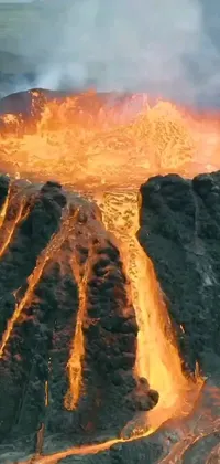 This phone live wallpaper showcases an aerial view of a mighty volcano erupting and spewing lava into the air