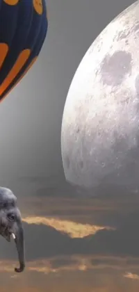 This stunning phone live wallpaper features an elephant standing next to a hot air balloon on a moon surface background