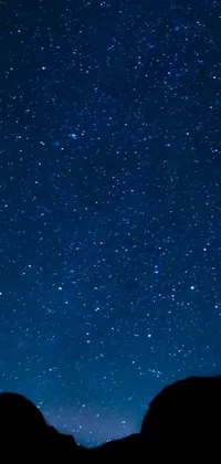 Get lost in the mesmerizing galaxy above with the night sky live wallpaper! Adorned with countless shining stars against a deep blue backdrop, this exquisite wallpaper guarantees to add a touch of beauty and serenity to your phone settings