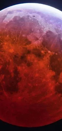 This mobile live wallpaper showcases a captivating starry night scene featuring a striking blood moon and its detailed red paint patterns against the dark sky