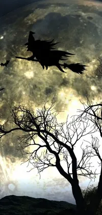This phone live wallpaper features a witch flying over a tree against the backdrop of a full moon