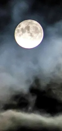 Looking for a moody and mysterious live wallpaper for your phone? This image captures a full moon shrouded by clouds, with smoke curling around it to create an air of menace