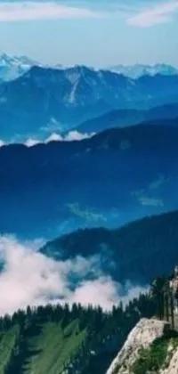 This phone live wallpaper features a group of people who have reached the summit of a mountain