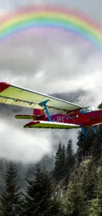 Enjoy a stunning live wallpaper of a soaring plane against a colorful rainbow backdrop