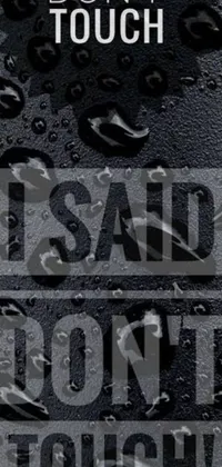 This live wallpaper features a black and white poster with the bold words &quot;don&#39;t touch&quot; in all caps