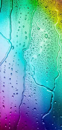 This live wallpaper displays water droplets on a window in colorful pastel hues, resembling a generative art piece