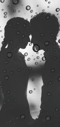 Get this stunning live wallpaper for your mobile today! It features a romantic black and white image of a couple kissing in the rain