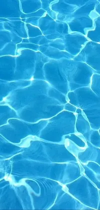 This live wallpaper, created by a digital artist, features a close-up view of a pool with a frisbee floating on the glowing blue water