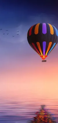 This live phone wallpaper depicts a charming hot air balloon gliding over the water, against a backdrop of colorful pastel sky