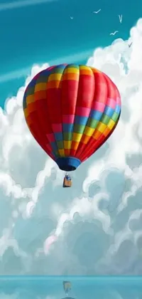 This live wallpaper depicts a charming scene of a colorful hot air balloon flying over the ocean, against a backdrop of vibrant puffy clouds and a shimmering sun setting in the distance