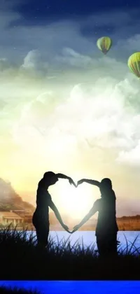 This phone live wallpaper features a charming romantic image of two individuals creating a heart with their hands