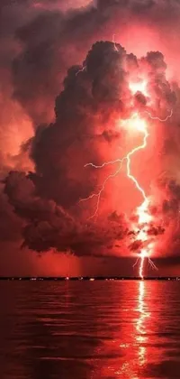 This live wallpaper features a stunning image of lightning bolts in the sky over water with red cumulonimbus clouds