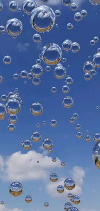This phone live wallpaper features a stunning display of floating bubbles against a clear sky backdrop