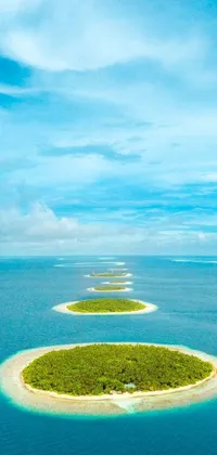 This phone live wallpaper showcases a group of small islands surrounded by clear blue waters