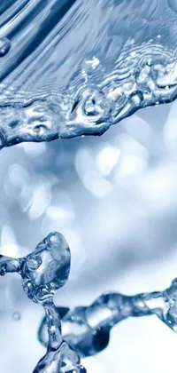 This live phone wallpaper is a captivating view of water flowing from a faucet