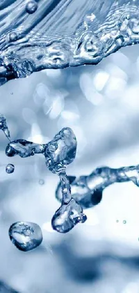This live wallpaper features a stunning close-up of a faucet pouring water