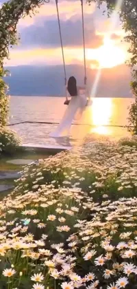 Enjoy a stunning live wallpaper showcasing a peaceful scene of a person swinging in a field of vibrant flowers created by a talented artist