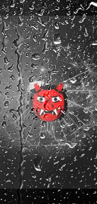 This captivating phone live wallpaper features a striking black and white image of a dandelion set against a dramatic red oni mask being worn by a villain