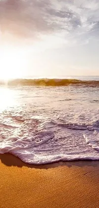 The phone live wallpaper depicts a serene beach with stunning waves and sunset scenery