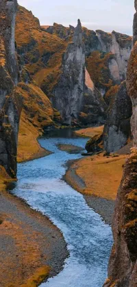This live wallpaper depicts a flowing river amidst a lush green valley