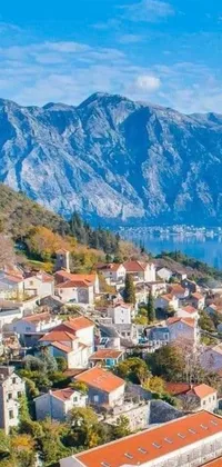 This phone live wallpaper depicts a serene coastal town situated at the foot of majestic mountains in Croatia