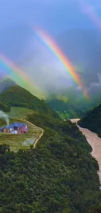 Enjoy a stunning live wallpaper on your phone screen! This charming scene shows a river flowing through a lush green valley, with a rainbow sitting above it