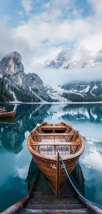 This stunning phone live wallpaper features a wooden boat resting on top of a serene lake, set against a picturesque Italian landscape