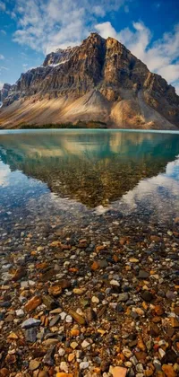 This live wallpaper features a stunning photograph of a serene body of water with a majestic mountain in the background, set against the beautiful backdrop of Banff National Park