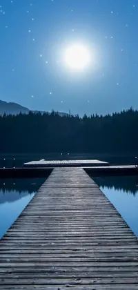 This beautiful phone live wallpaper features a serene lake with a dock under a full moon