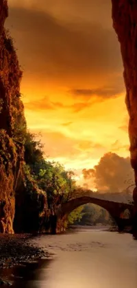 Enjoy a serene sunset scenery on your phone with this stunning live wallpaper of a bridge over calm water